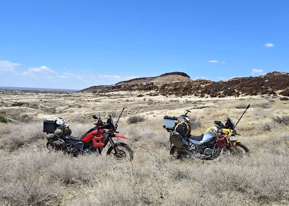 Loaded motorcycles in lava country with the lake on the horizon